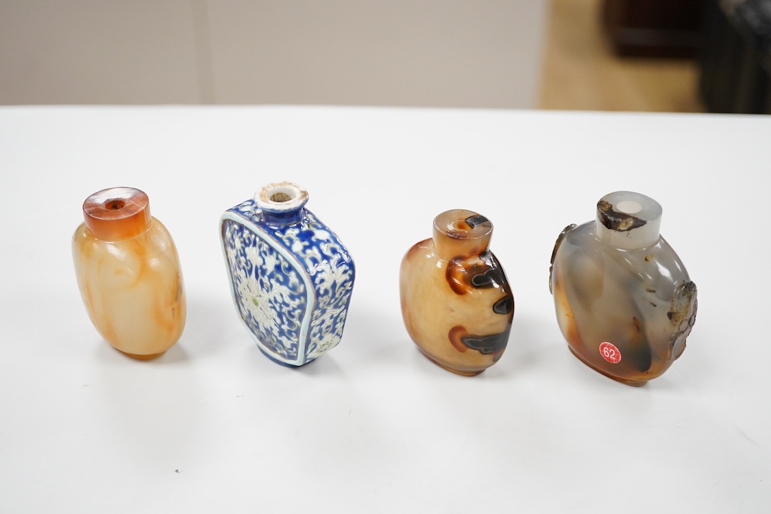 Three 19th century Chinese agate snuff bottles and a porcelain snuff bottle, largest 6cm high (4)